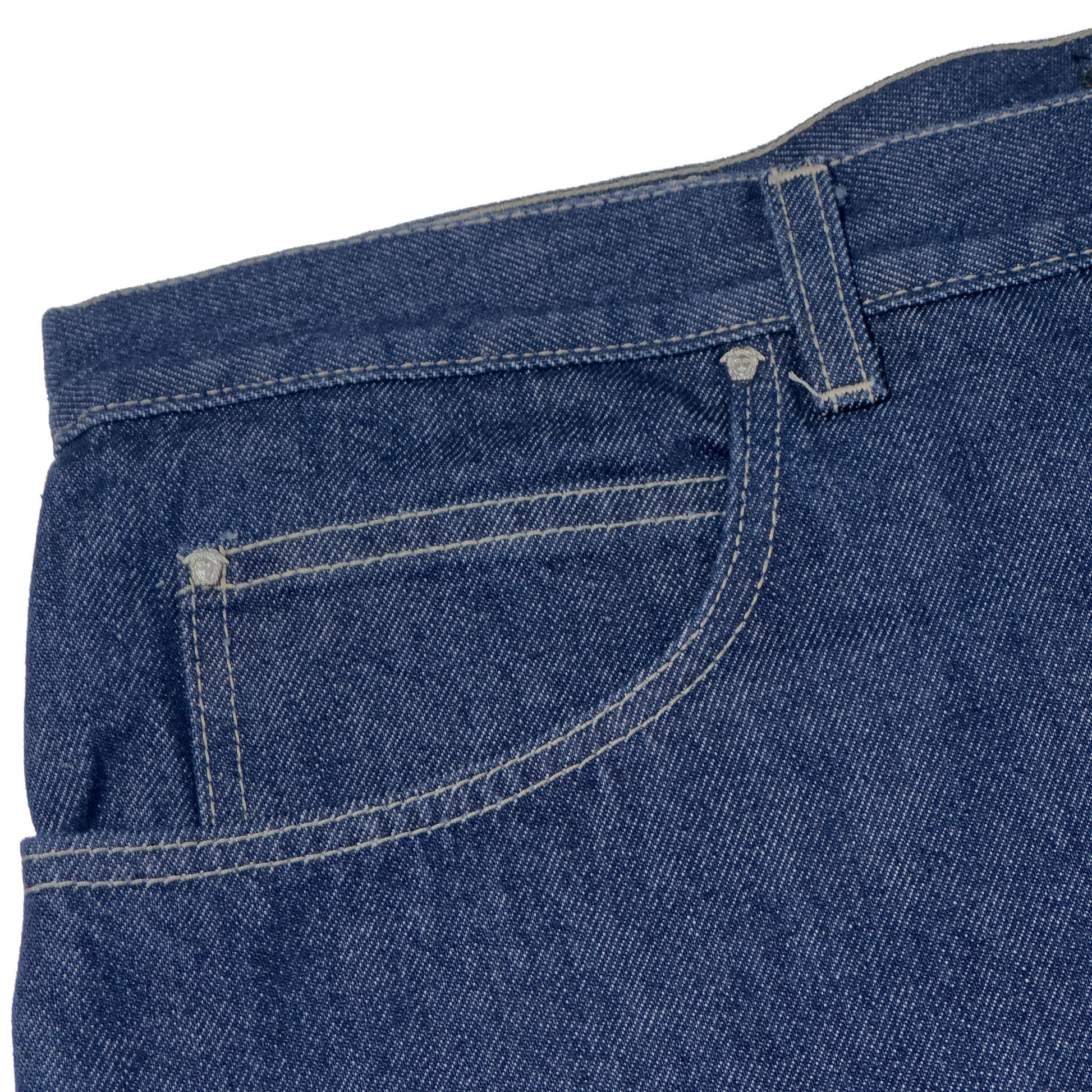 close up of versace blue jeans with versace buttons